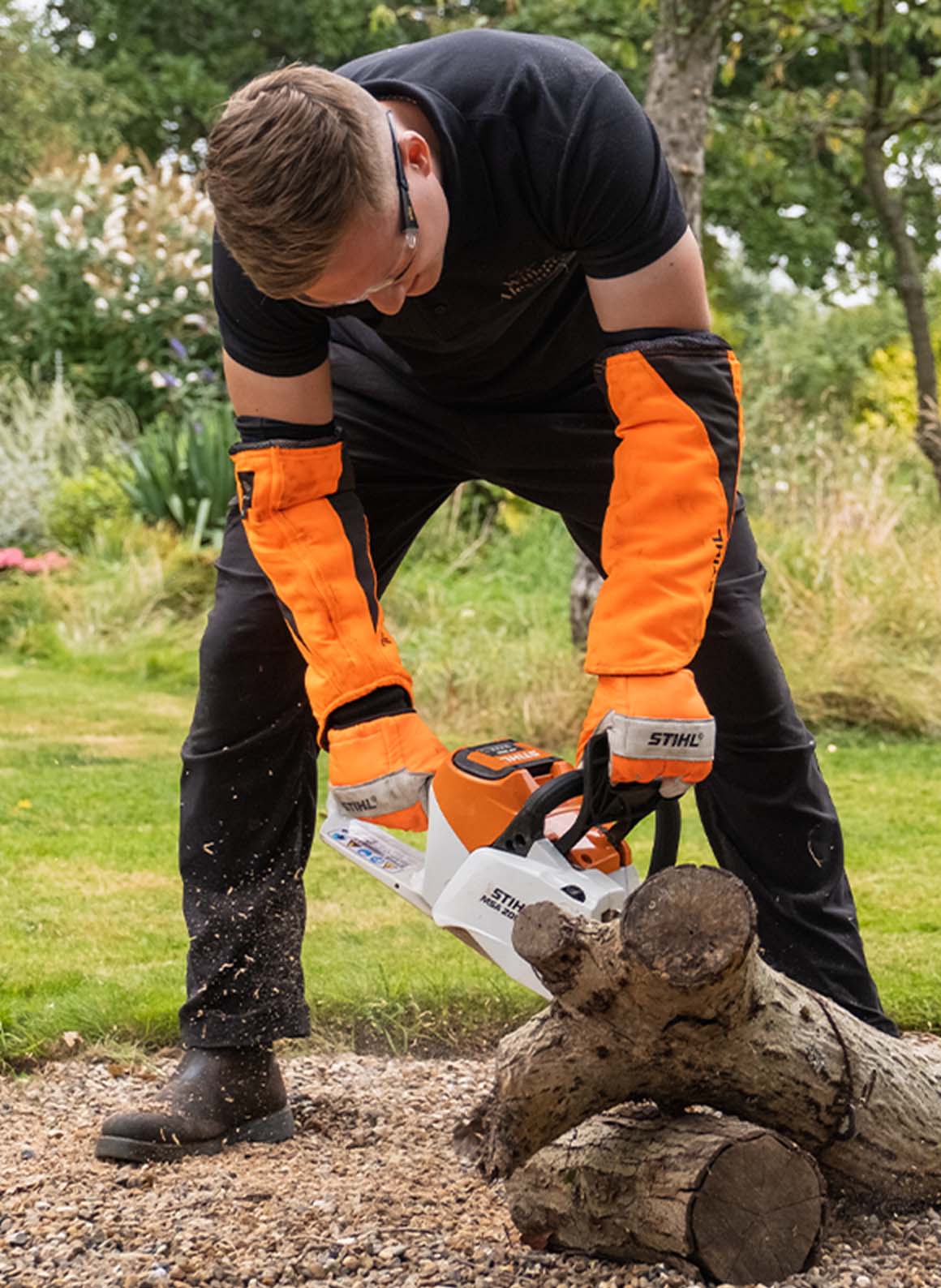 One of the Willow team chain sawing a log